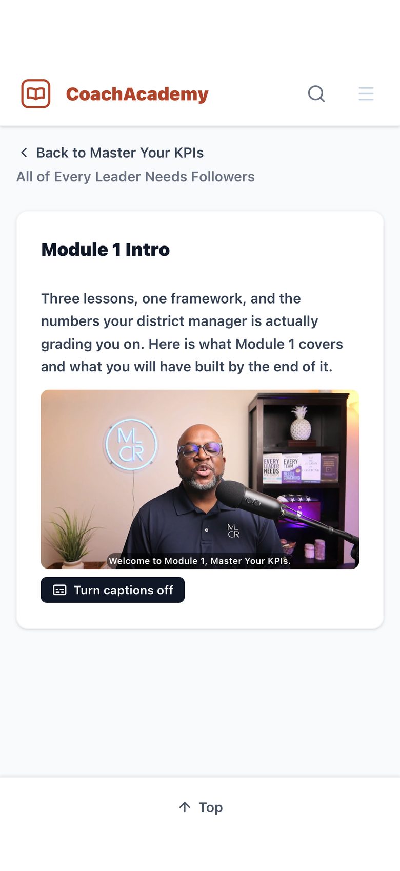 Module 1 Intro video playing on a phone with captions on, reading: Welcome to Module 1, Master Your KPIs.